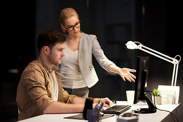 Image showing business team with computer working late at office