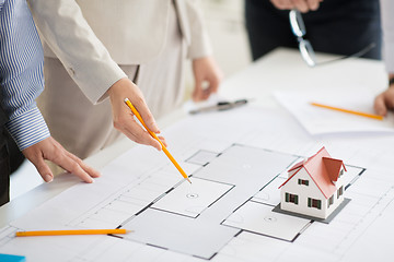 Image showing close up of architects with blueprint at office