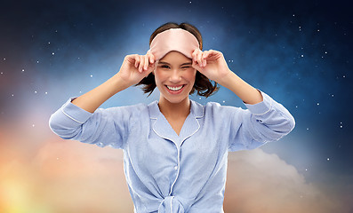 Image showing happy young woman in pajama and eye sleeping mask