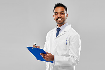 Image showing smiling indian doctor or scientist with clipboard