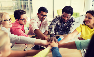 Image showing group of international students with hands on top