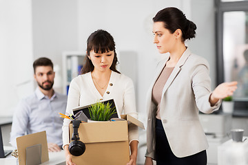 Image showing fired sad female office worker leaving