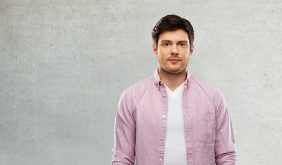 Image showing young man over grey concrete wall