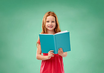 Image showing red student girl with book over school chalk board