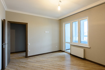 Image showing The interior of the room is unfurnished with new renovations, the front door and the balcony exit