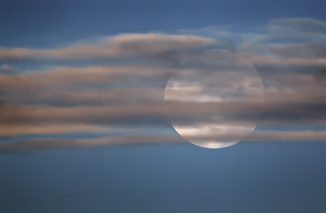 Image showing Full Moon In The Sky Behind The Clouds