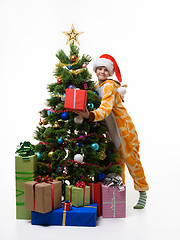 Image showing Girl with a gift hugs Christmas tree