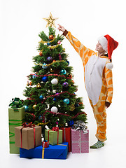 Image showing Girl shows off star on Christmas tree