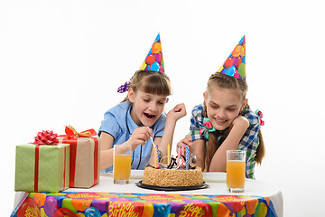 Image showing Children eat a birthday cake with a spoon, isolated on a white background