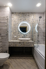 Image showing Interior of a stylish modern combined bathroom and toilet