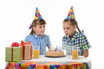 Image showing Children blow out candles on a birthday cake