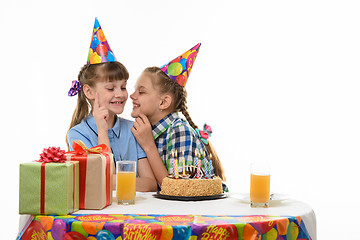 Image showing Children keep secrets and talk while sitting at the holiday table