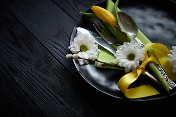 Image showing Easter spring table dishware composition with yellow tulip flower