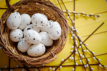 Image showing Whole chicken eggs in brown wicker basket. The concept of Easter Holidays