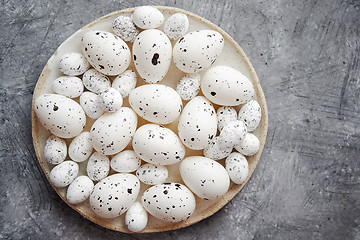 Image showing Composition of white traditional dotted Easter eggs in white ceramic plate