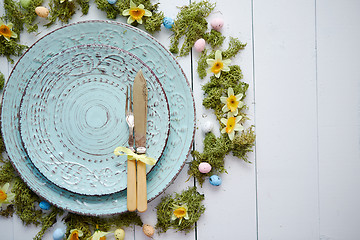Image showing Easter table setting with flowers and eggs. Empty decorative ceramic plates