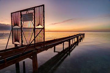 Image showing Overpass with pipes going out to sea at sunset