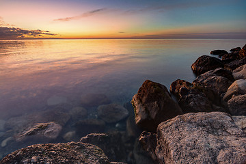 Image showing Calm beautiful evening seascape, in the foreground huge stones