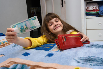 Image showing A girl asks for a thousand rubles, pulling them out of moms purse