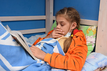 Image showing Sick girl coughs lying in bed