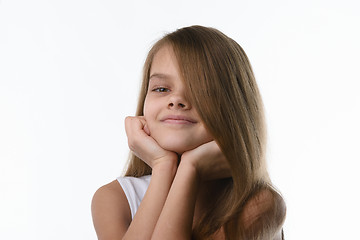 Image showing Portrait of a close-up of a girl covering part of her face with her hair