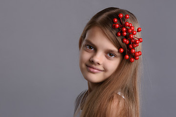 Image showing Portrait of a beautiful teenage girl with a bunch of berries in her hand and in her hair