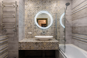 Image showing The washstand and bathroom in the interior of a small and modern bathroom