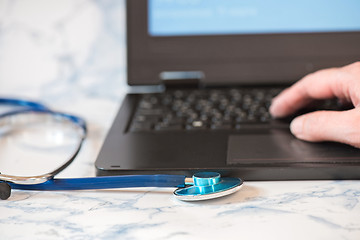 Image showing Stethoscope and notebook