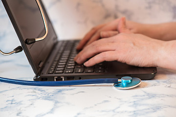 Image showing Stethoscope and notebook