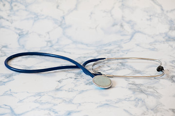 Image showing Medical stethoscope or phonendoscope over light blue background