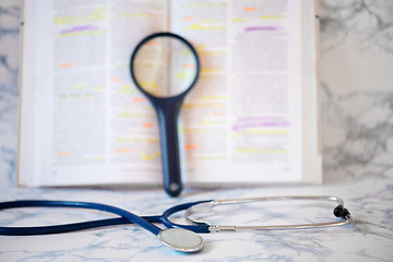 Image showing Stethoscope, magnifier and book