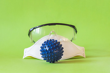 Image showing Protecting mask and glasses on the table and microscope virus close up,. Coronavirus concept