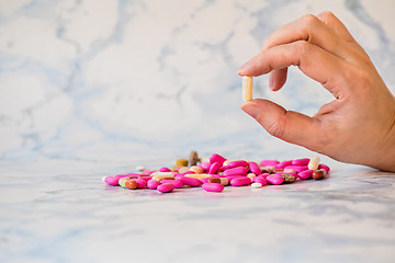 Image showing Tablet in the fingers of hand