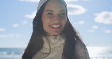 Image showing Girl In Autumn Clothes Smiling on beach