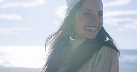 Image showing Girl In Autumn Clothes Smiling on beach