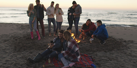 Image showing Friends having fun at beach on autumn day