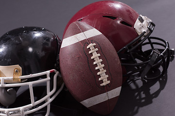 Image showing american football and helmets isolated on gray