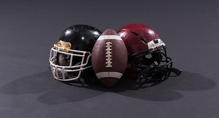 Image showing american football and helmets isolated on gray