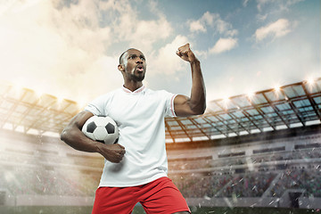 Image showing The football player in motion on the field of stadium