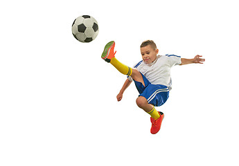 Image showing Young boy with soccer ball doing flying kick