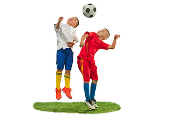 Image showing Young boys with soccer ball doing flying kick