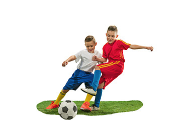 Image showing Young boys with soccer ball doing flying kick