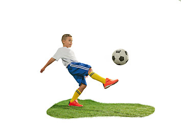 Image showing Young boy with soccer ball doing flying kick