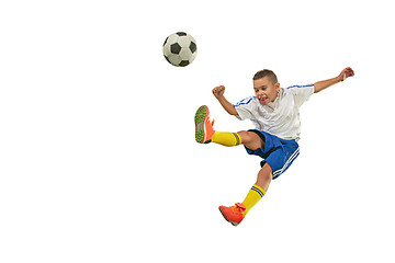 Image showing Young boy with soccer ball doing flying kick