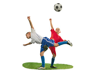 Image showing Young boys with soccer ball doing flying kick