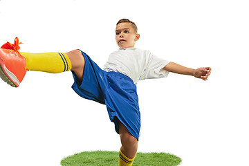 Image showing Young boy with soccer ball doing flying kick