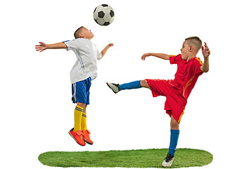 Image showing Young boys with soccer ball doing flying kick