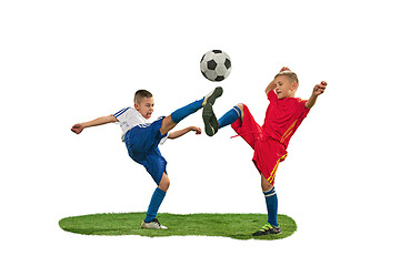 Image showing Young boys with soccer ball doing flying kick