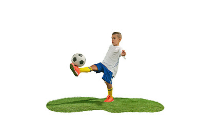 Image showing Young boy with soccer ball doing flying kick