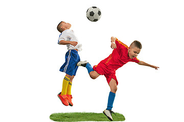 Image showing Young boys with soccer ball doing flying kick